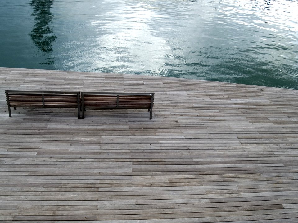 aerial photography of bench near body of water