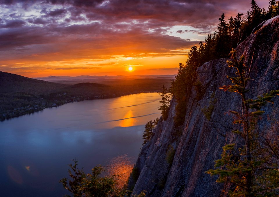 gray cliff near body of water during golden hour