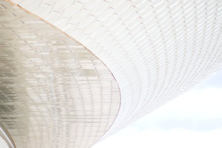 A view of white patterned architecture from below.