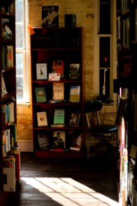 brown wooden shelf with assorted books photo