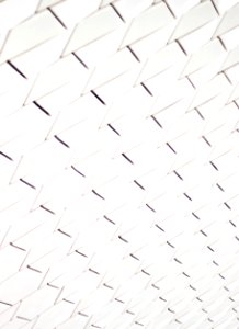 A pattern of white geometric shapes in a facade