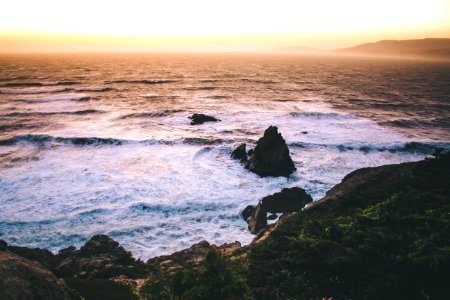 photo of sea shore with rocks photo