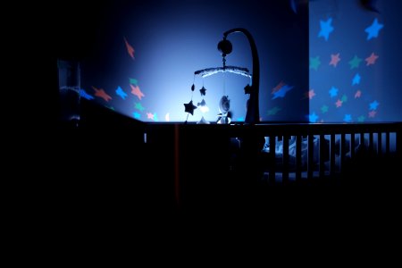 baby's black wooden crib with LED crib mobile photo