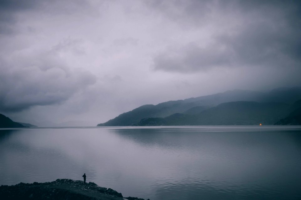 man standing on gray mountain photo