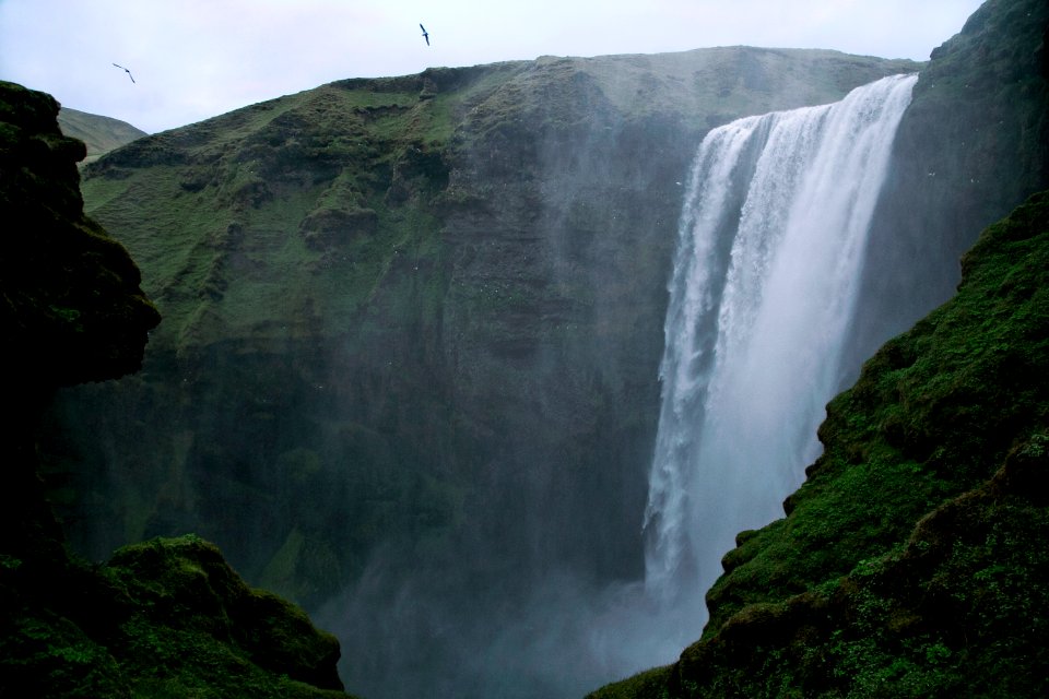 waterfalls surrounded by mountains