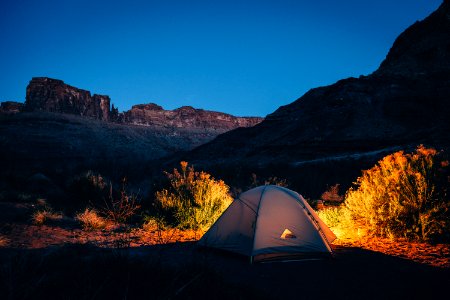white camping tent beside mountain photo