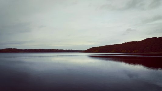 body of water near mountain during daytime photo