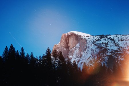 photography of mountain near forest trees during daytime photo