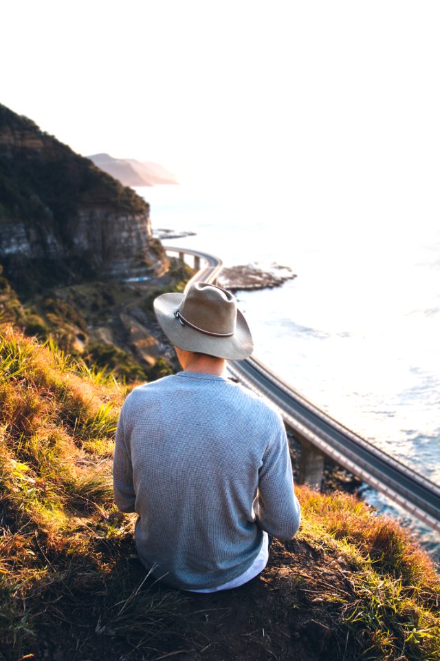 person sitting on cliff