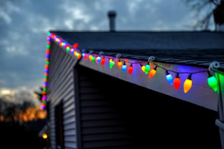 selective focus photography of string lights on roof top edge photo