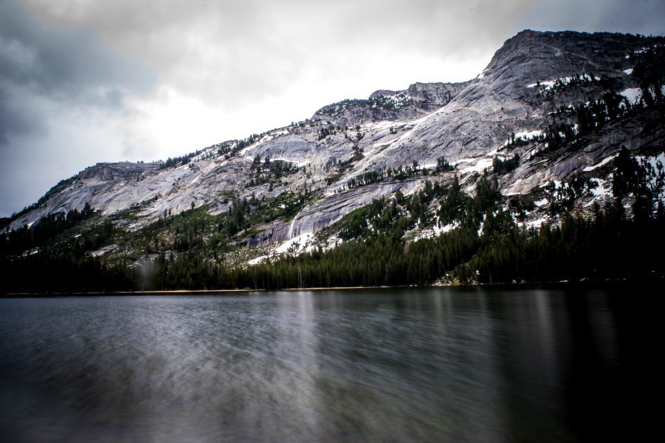 long exposure photo of body of water and mountains