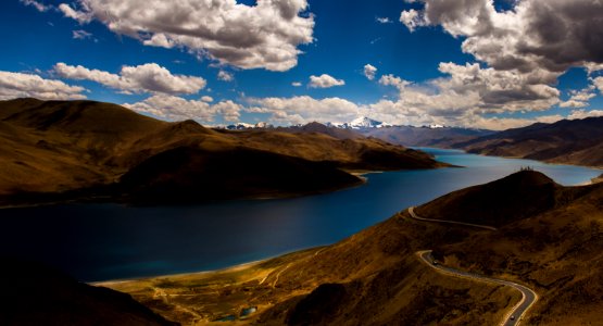 aerial photo of road in a distance of lake and mountain