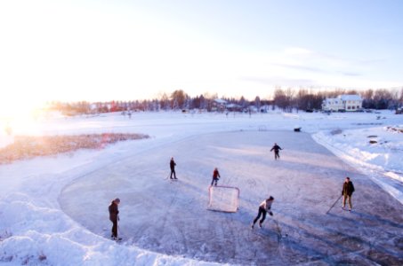 group of people playing outdoor hockey during winter photo
