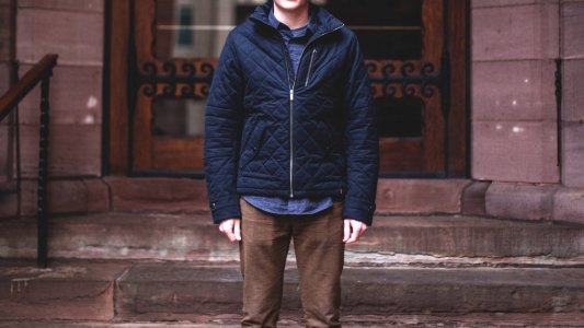 person standing on stairs near door photo