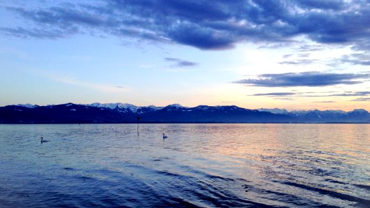 body of water in front of the mountain photo