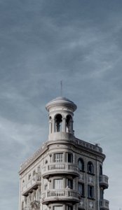 concrete building under cloudy sky photo