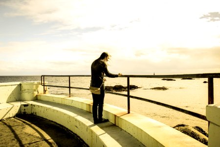 person standing on building rooftop during daytime photo