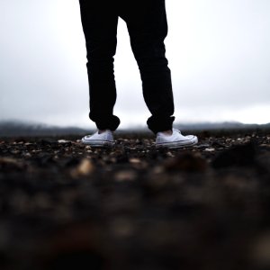 person wearing white low-top sneakers photo