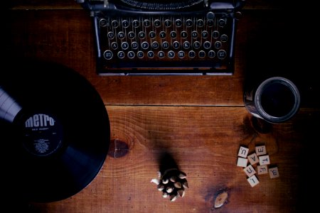 black typewriter beside black Metro vinyl record photo