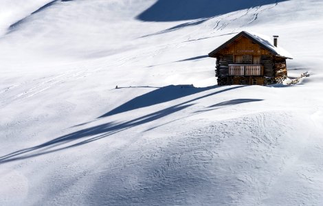 brown wooden house covered of snow photo