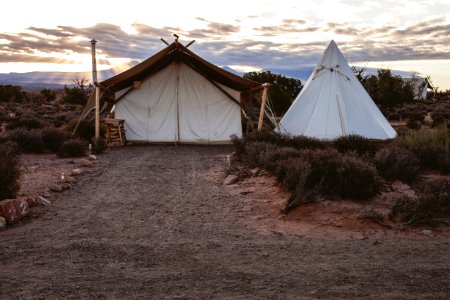 white tipi tent surrounded by grass photo