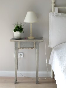 white table lamp on gray end table