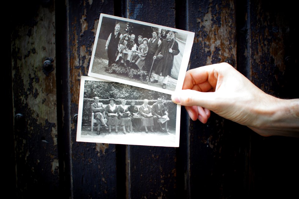 person holding vintage photos