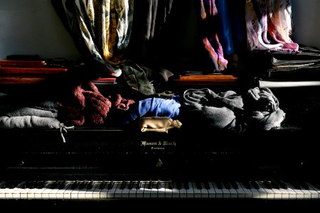assorted clothes on top of piano