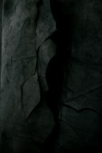 Darkened image of a rock wall.
