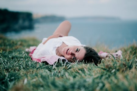 woman lying on green grass photo