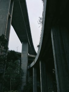 grey scale and low angle photography of grey concrete bridge photo