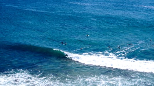 aerial shot of person surfing on ocean photo