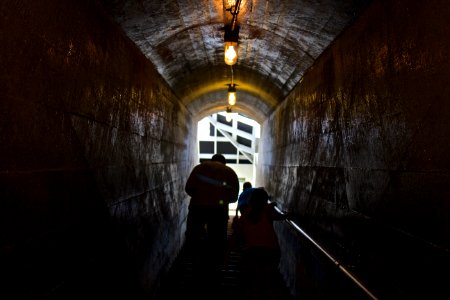 man and child passing through tunnel