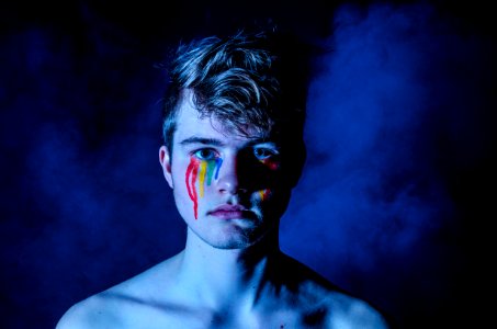 photo of man crying with colored tears photo