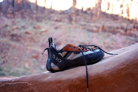 black and white shoes place on rock formation photo