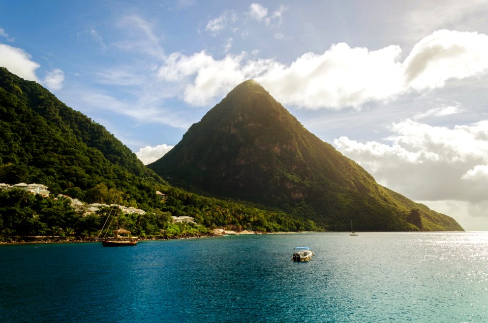 white board on body of water near mountain during daytime photo