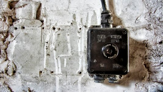 grey and black corded device on wall photo