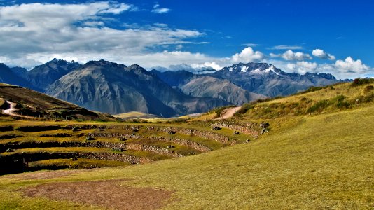 landscape photography of mountain under white clouds and blue sky photo