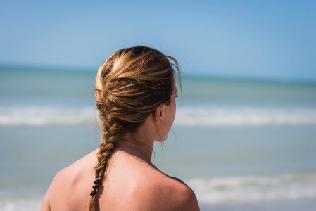 back view photo of woman with braided hair near sea photo