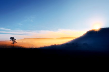 silhouette photography of mountain under blue sky