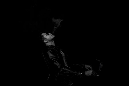 grayscale photo of man with cigarette stick