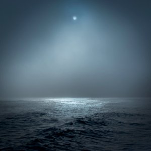 full moon lighted body of water photo