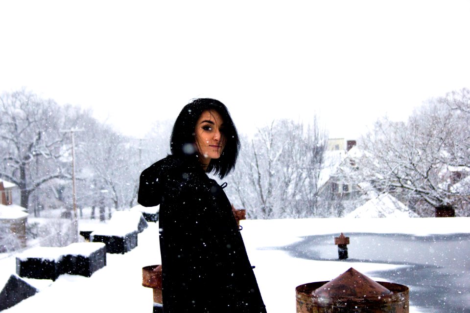 woman wearing black shirt standing under snow weather