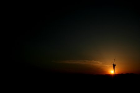 silhouette of windmill under golden hour photo