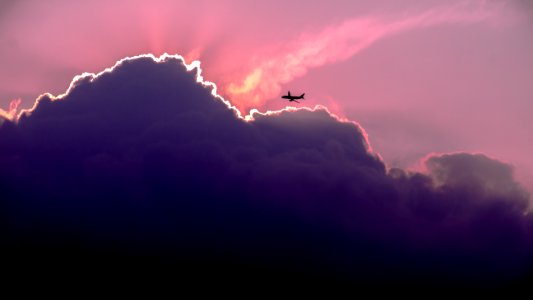 silhouette of airplanes of white clouds photo