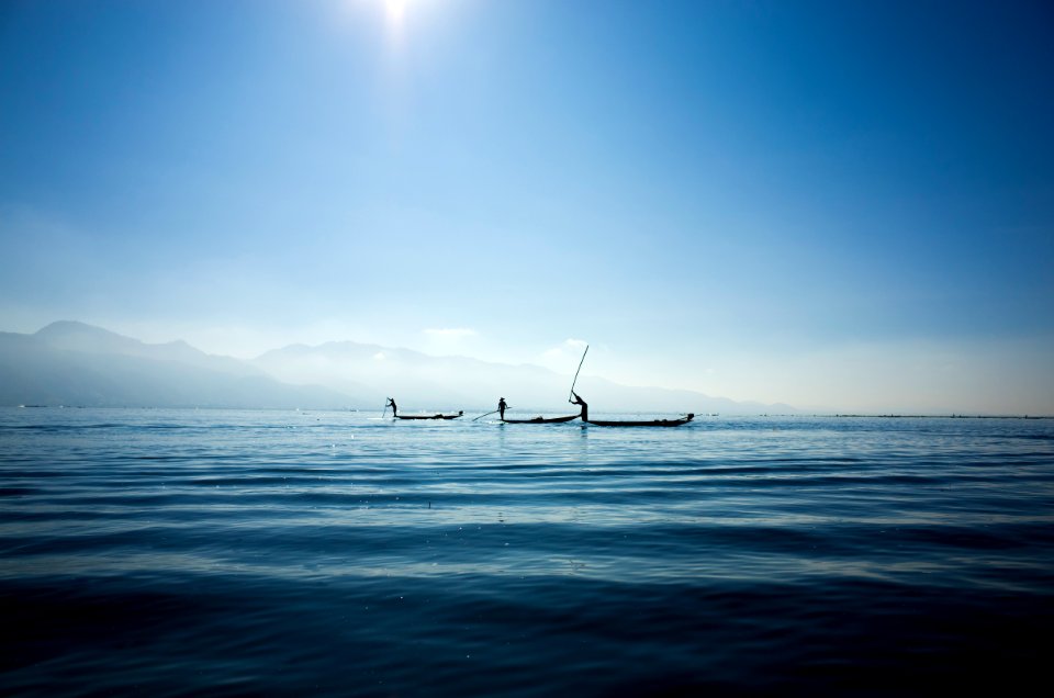calm body water under blue sky