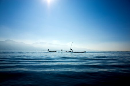 calm body water under blue sky