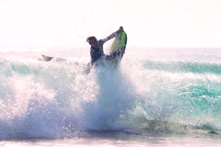 man riding bodyboard photo