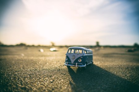shallow focus photography of white and teal die-cast Volkswagen Samba with sunlight photo