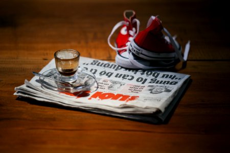 teacup on saucer on top of newspaper photo
